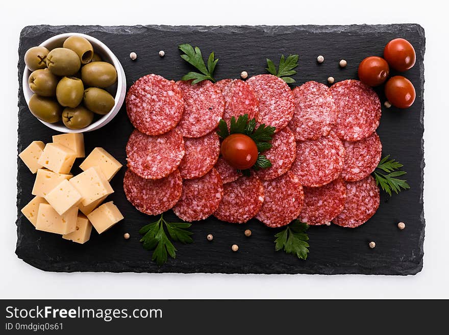 Delicious sliced salami on a stone plate. Delicious sliced salami on a stone plate.