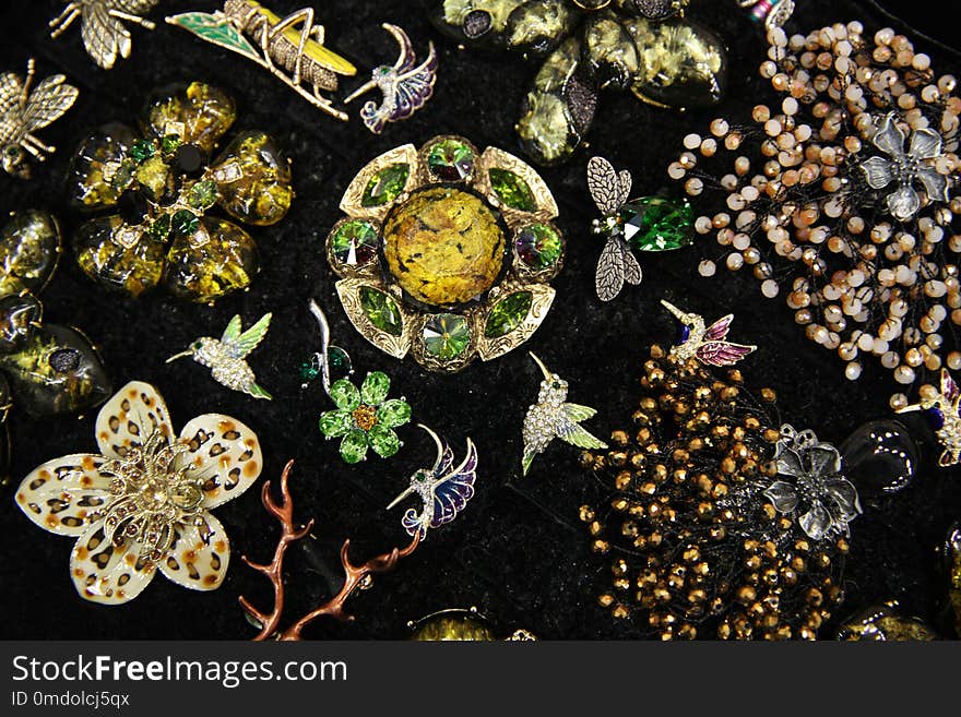 Large brooches in the form of flowers with natural precious stones