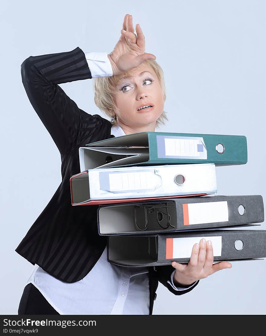 Astonished business woman with stack of documents. the concept of solving business problems