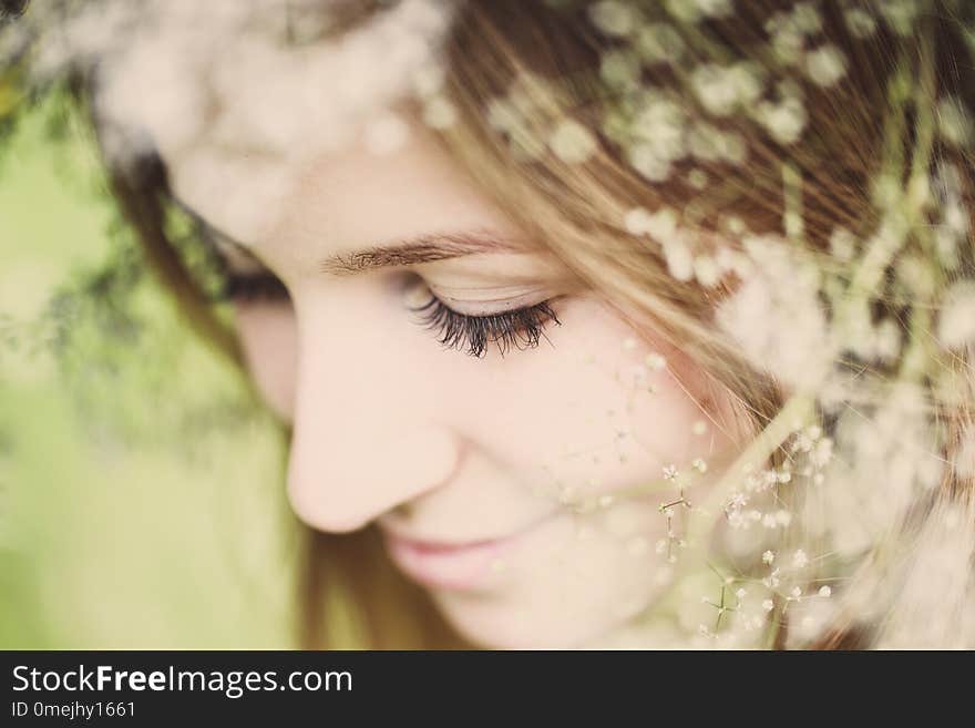 A girl in a wreath of field flowers