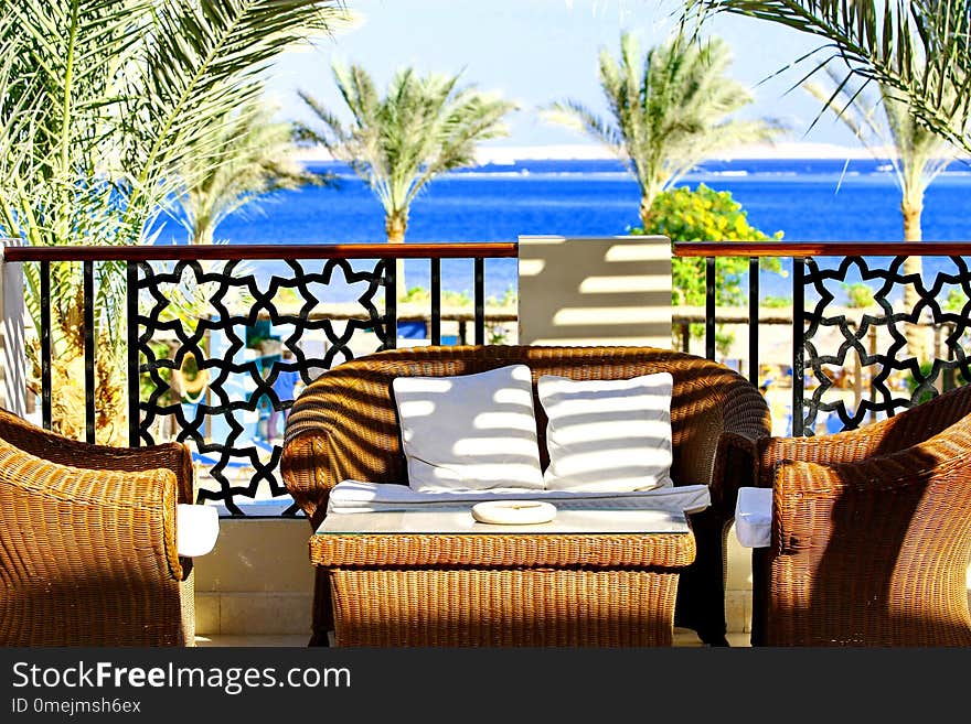 Villa terrace with wicker furniture and sea view