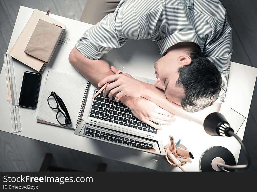 Top View Of Handsome Worker Sleeping On The Table