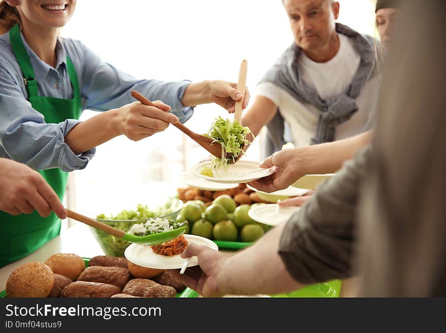 Volunteers Serving Food For Poor People