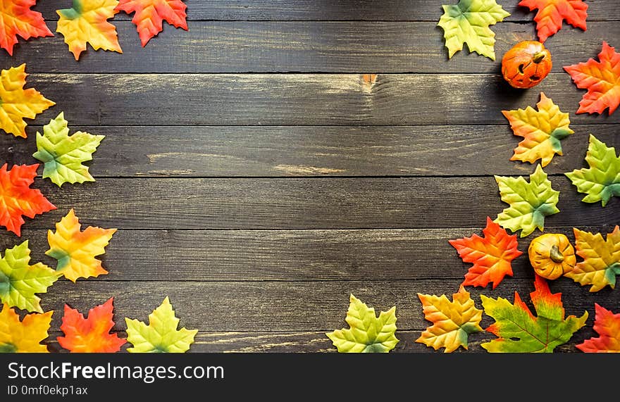 Colorful flat lay of Autumn leaves on rustic wooden table, copy space. Colorful flat lay of Autumn leaves on rustic wooden table, copy space