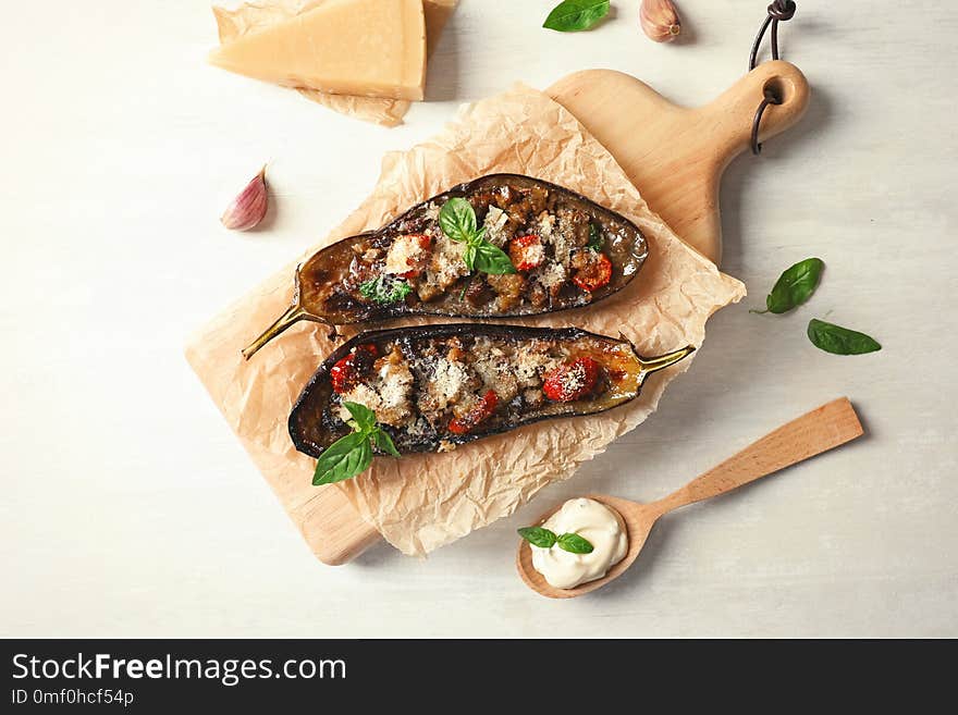 Flat lay composition with stuffed eggplants on light table