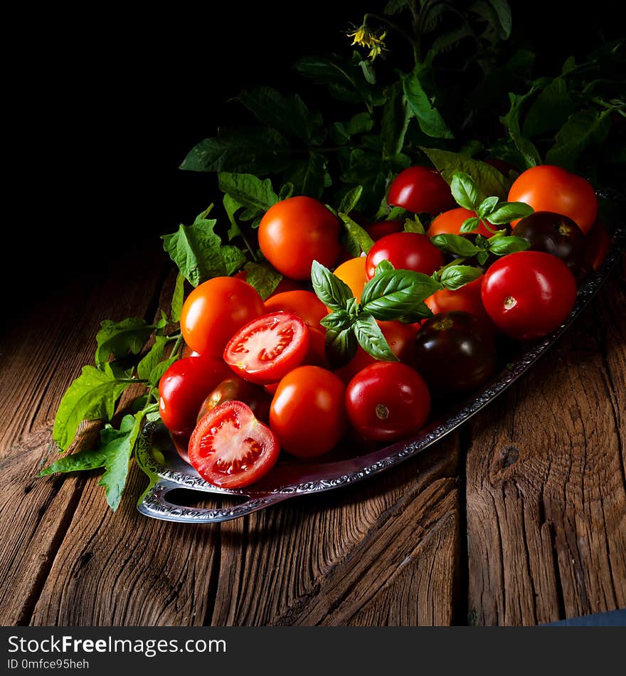 Various types of tomatoes served and presented on the silver platter.