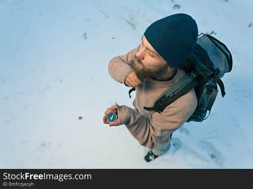 Traveller With Compass In Winter Forest