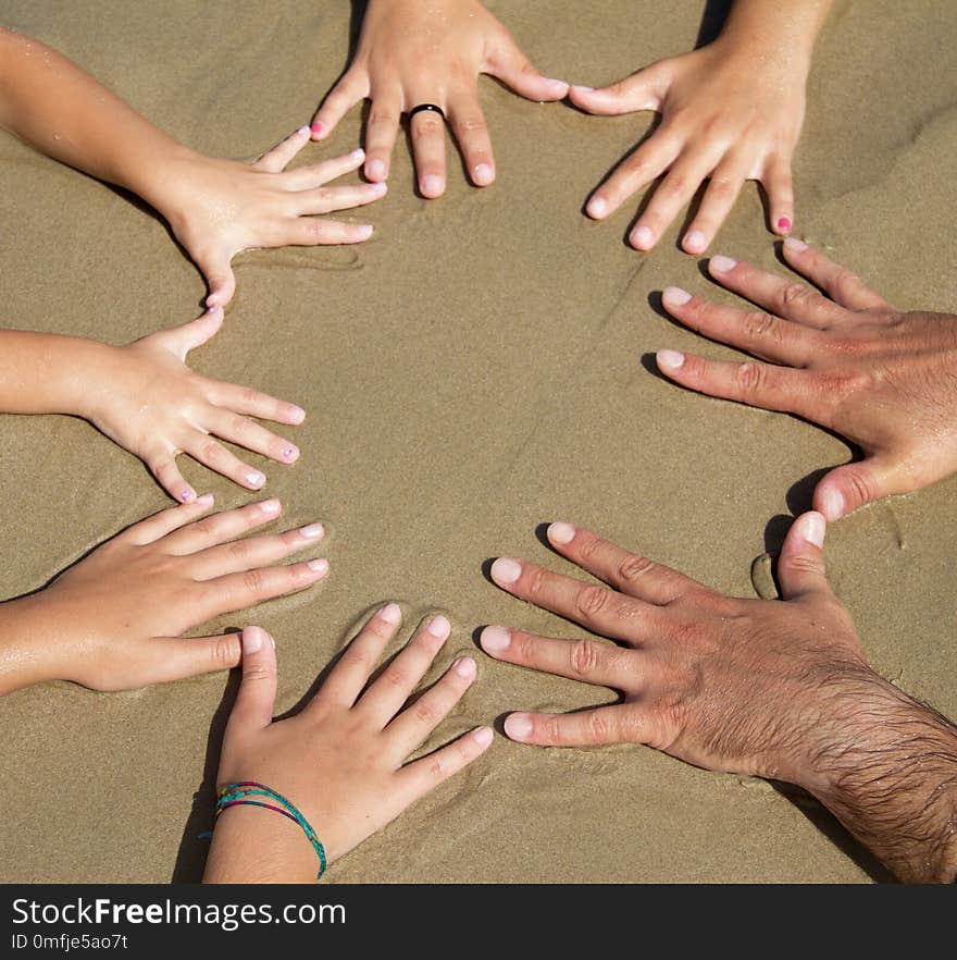 Many hands together on the beach