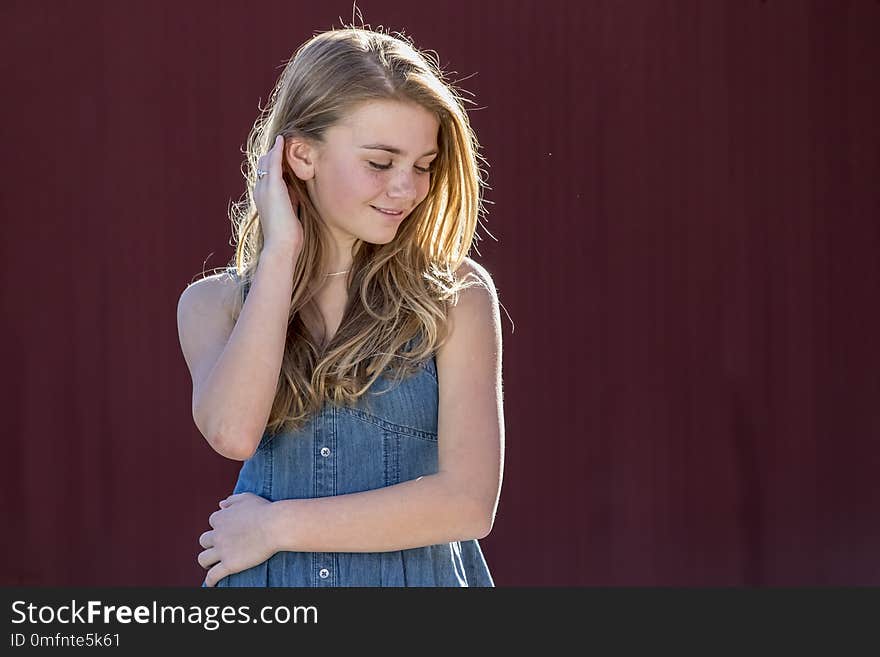 A beautiful young teenage blonde girl enjoying a beautiful day outdoors. A beautiful young teenage blonde girl enjoying a beautiful day outdoors