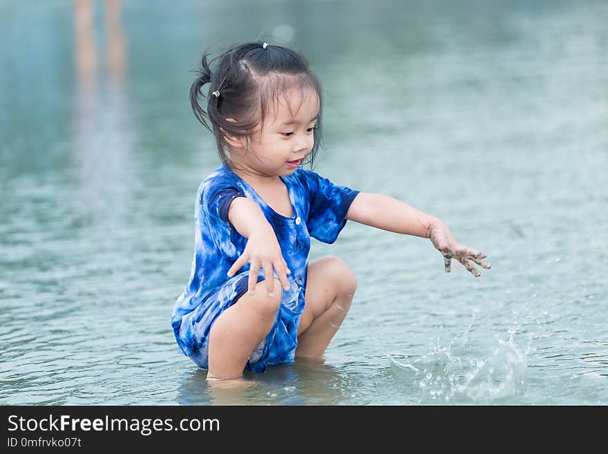 Close up of Happy girl playing on the beach.