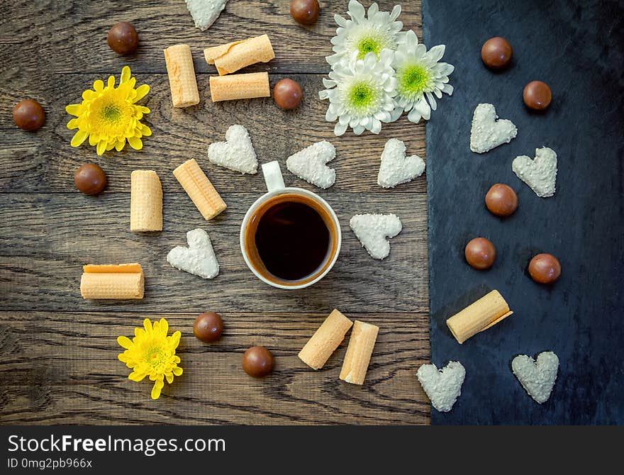 Coffee In A Cup, Sweets And Flowers On The Table