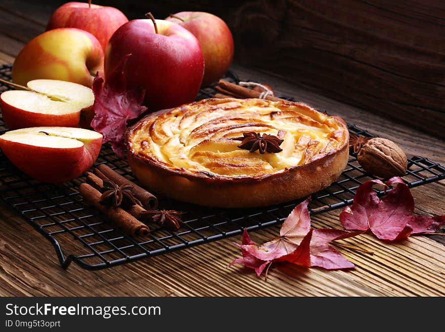 Apple tart. Gourmet traditional holiday apple pie sweet baked dessert food with cinnamon and apples on vintage background. Autumn decor. Rustic style