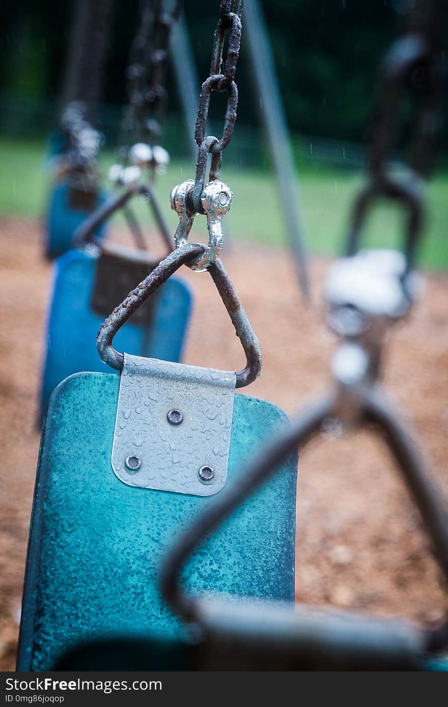 Empty playground during heavy rain downpour. Swings are left alone as no children will come out to play in the wet weather. Empty playground during heavy rain downpour. Swings are left alone as no children will come out to play in the wet weather