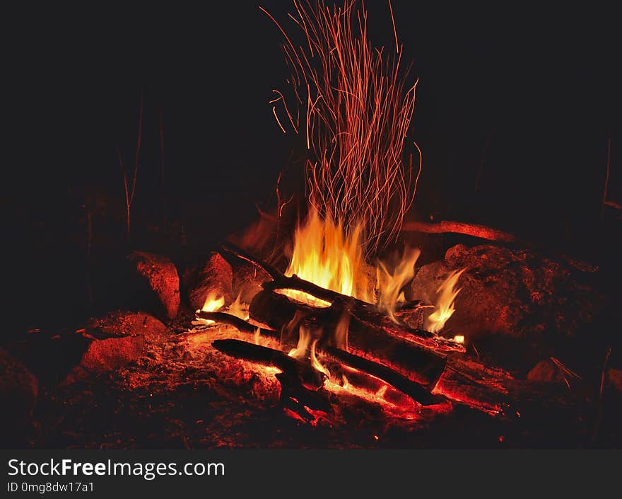 A close up of the aflame bonfire with sparks. A close up of the aflame bonfire with sparks.