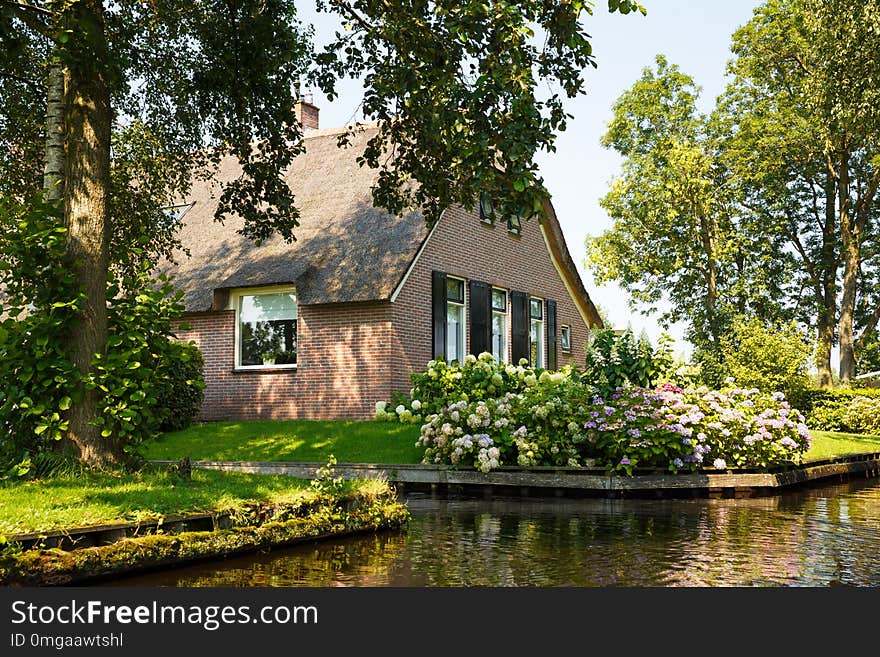 The thatched roof house with beatiful garden in fairytale village Giethoorn in The Netherlands.