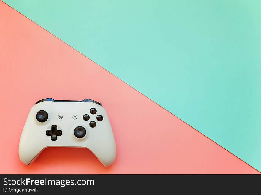 White joystick on pink and blue background