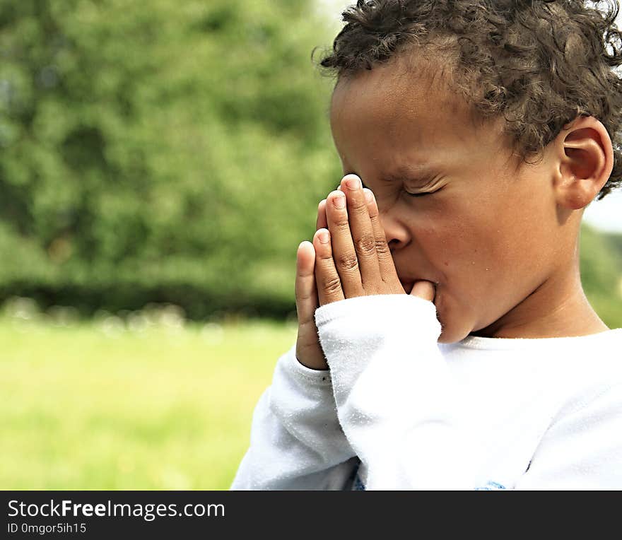 Little boy praying to God with hands held together