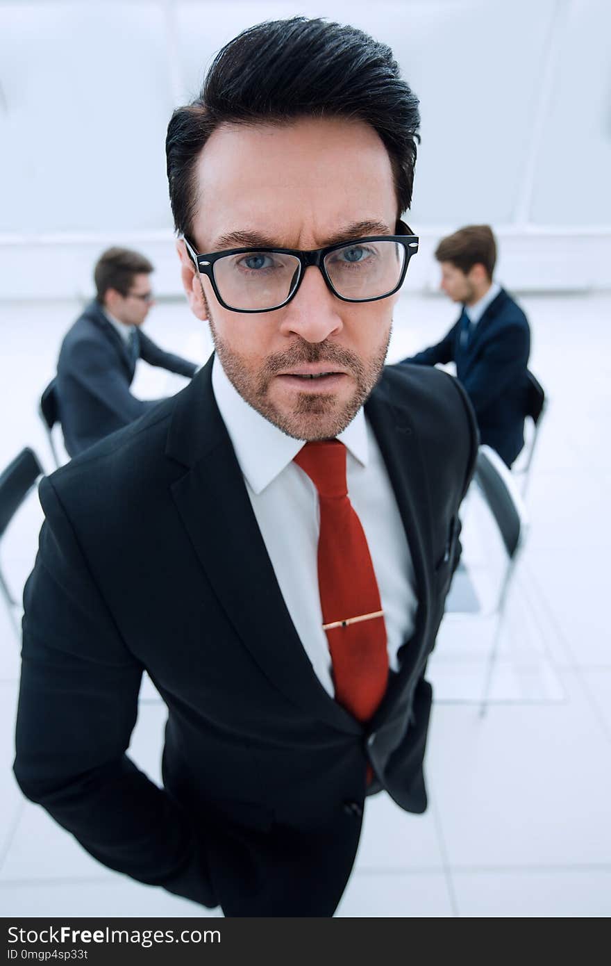 Close Up.serious Businessman Standing In The Conference Room