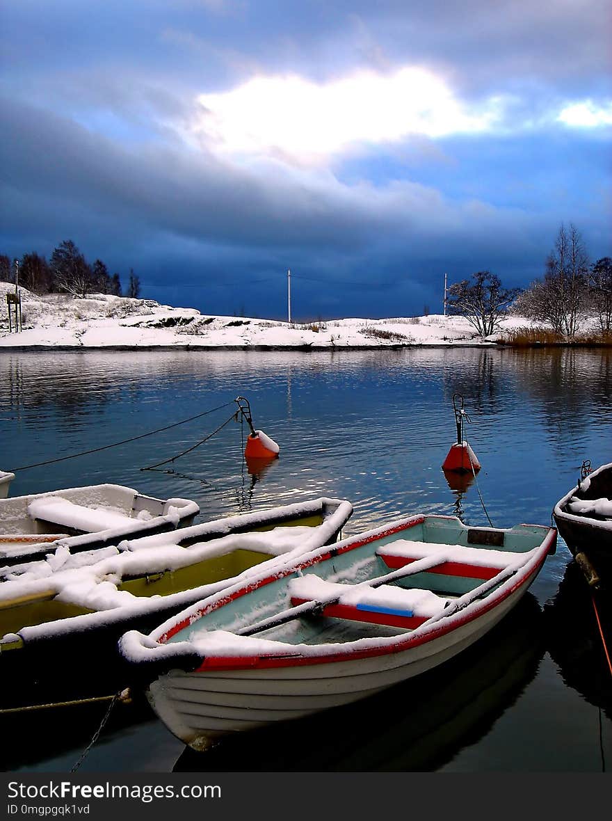 Fishing boat under a layer of snow and ice