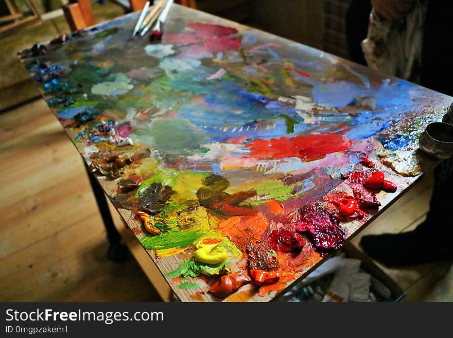 nbright palette of the artist, with many colors and shades of oil paint