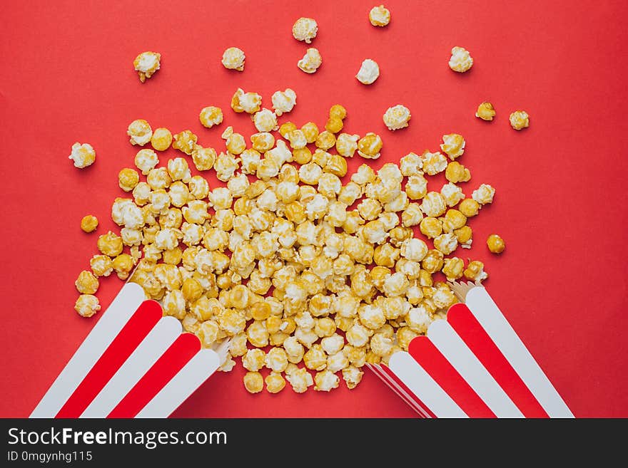 Popcorn on a red background top view in cinema