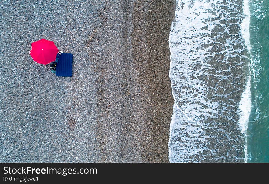 Beach umbrella on the shore of the Black Sea next to Kobuleti. Aerial photography.