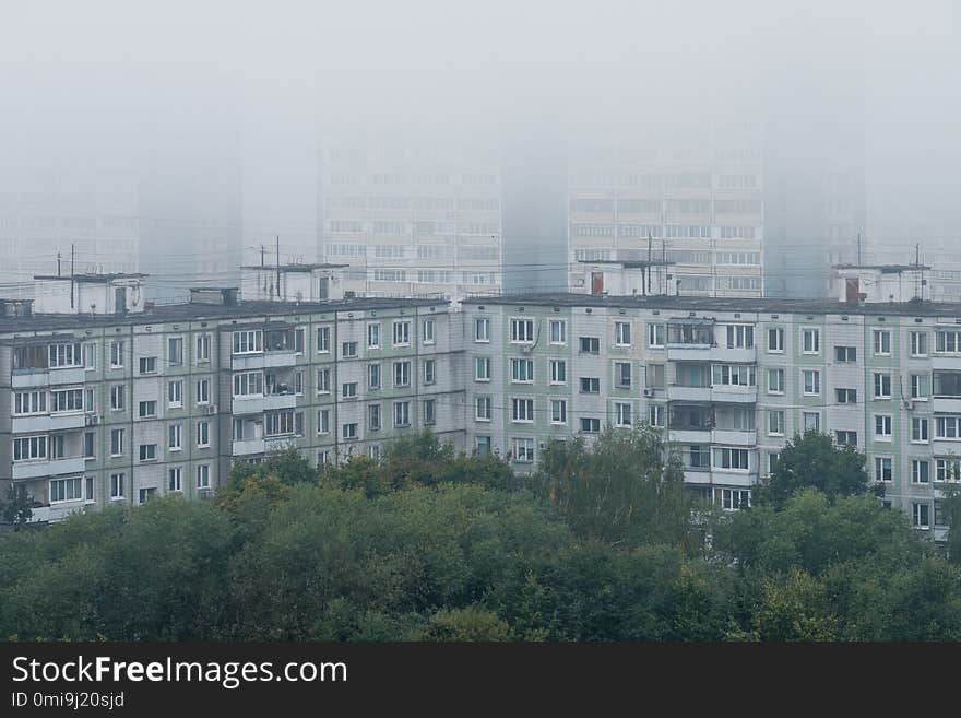 Morning mist over panel houses in early autumn