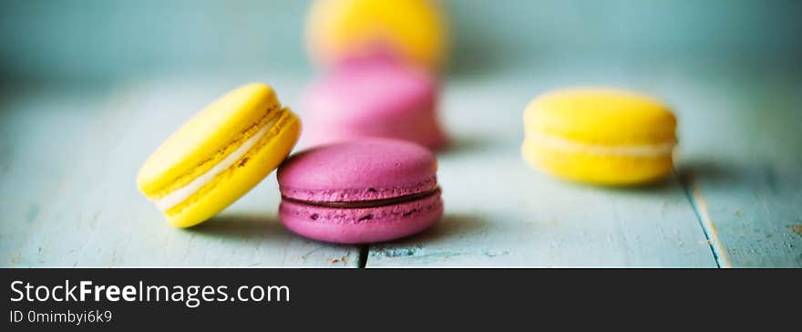 colourful macaroons on blue wooden background. colourful macaroons on blue wooden background