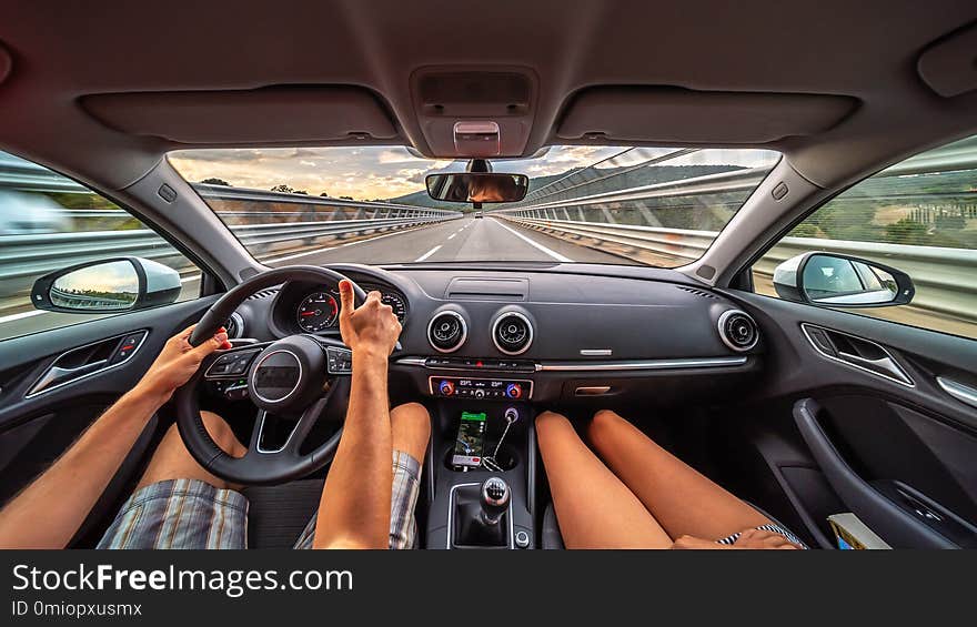 Driver`s hands on a steering wheel of a car