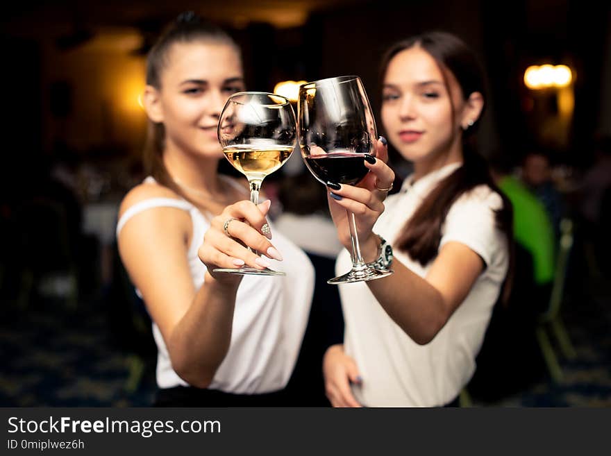 Two girls with glasses of wine