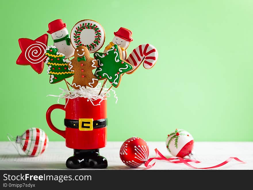 Set of Christmas gingerbread on sticks in a red gift cup. Christmas concept with copy space. Set of Christmas gingerbread on sticks in a red gift cup. Christmas concept with copy space.