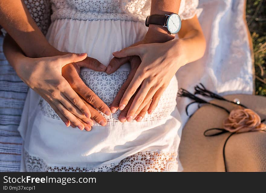 Happy parents are holding the pregnant belly.