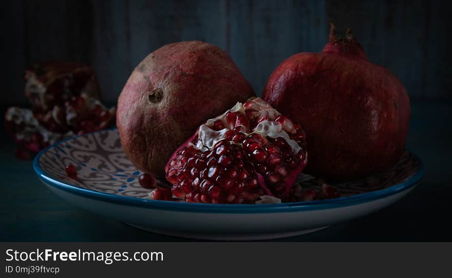 Still life grenade fruit. Feed on a black background.