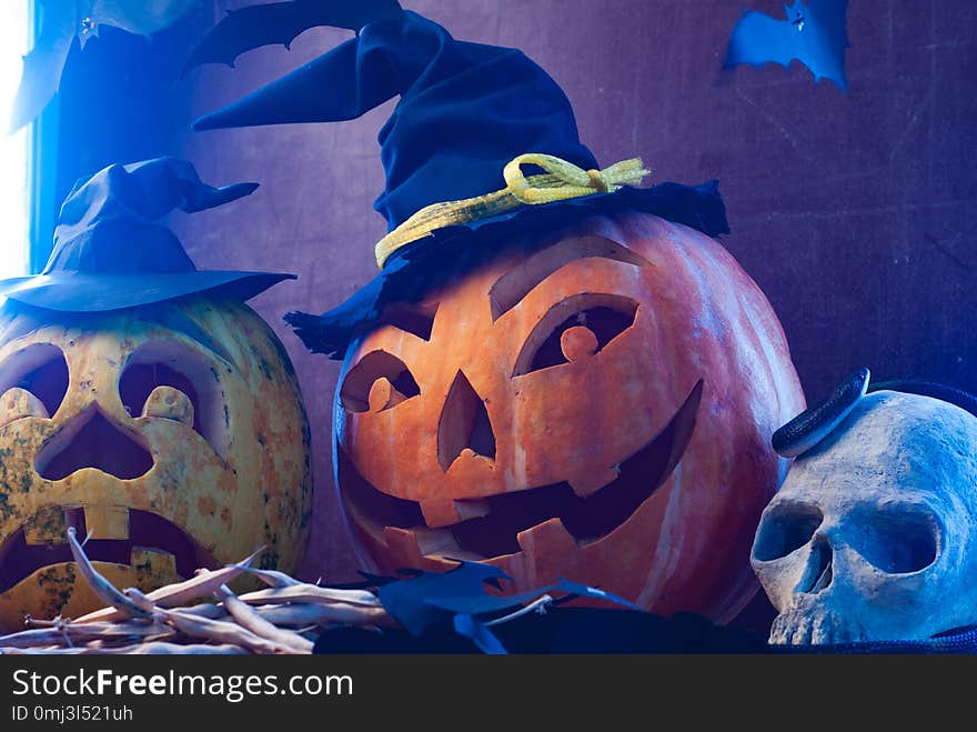 Halloween pumpkins in blue light, scary skull, Halloween background