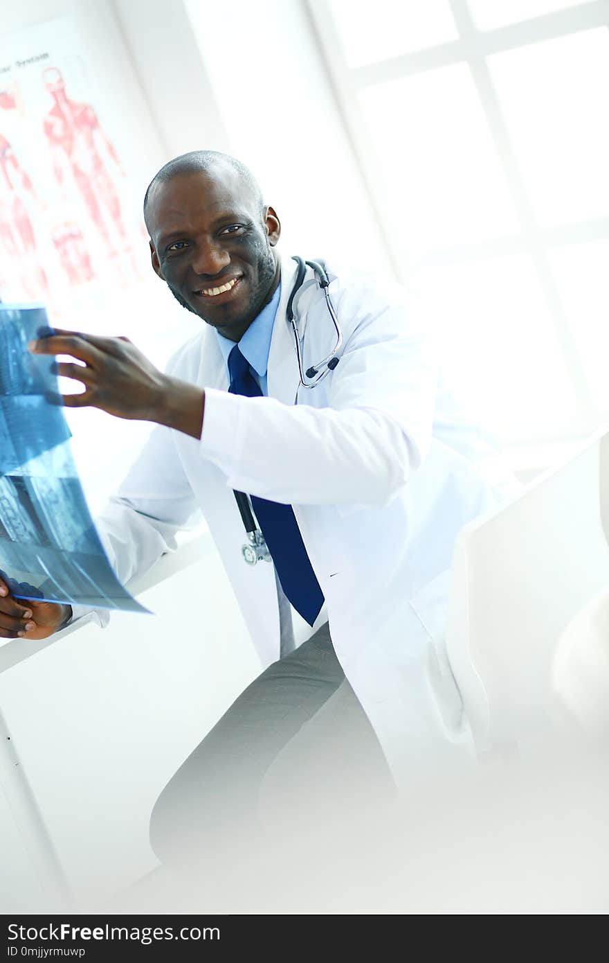 Portrait young african medical doctor holding patient`s x-ray.