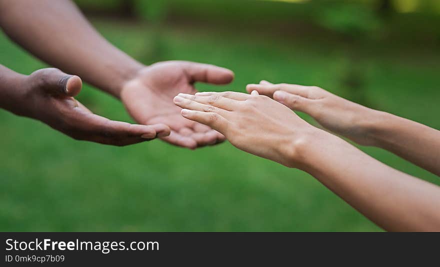 Diverse Male And Female Hands Stretch To Each Other