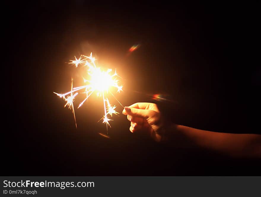 Female hand holding a burning sparkler