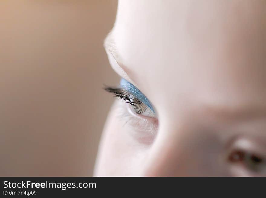 Teenager girl& x27;s face with makeup. Blue eye shadows. Close up.