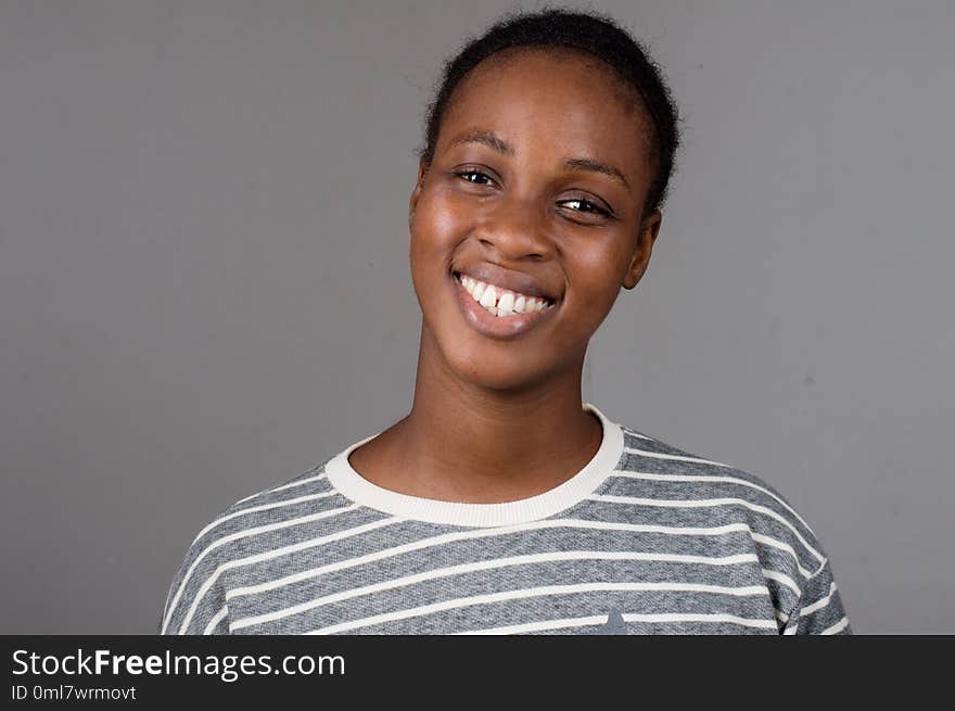 Portrait Beautiful happy woman with white teeth on a gray background. Portrait Beautiful happy woman with white teeth on a gray background