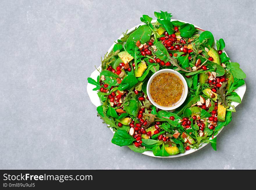 Christmas Wreath Salad with Pomegranate, Avocado, Salad Mix and Almond, Healthy Eating, Festive Appetizer. Christmas Wreath Salad with Pomegranate, Avocado, Salad Mix and Almond, Healthy Eating, Festive Appetizer