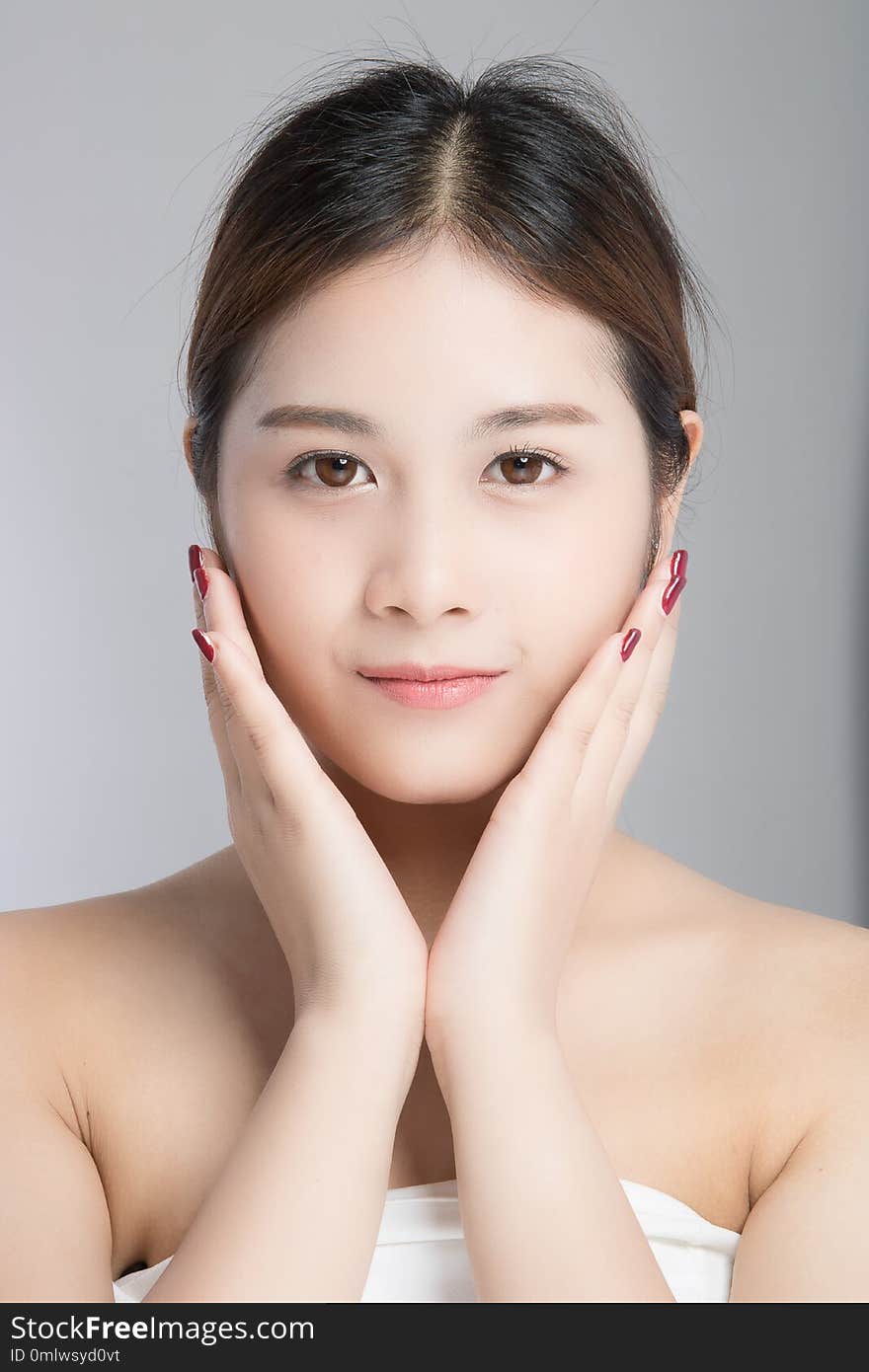 Attractive beautiful asian woman skin care on white background