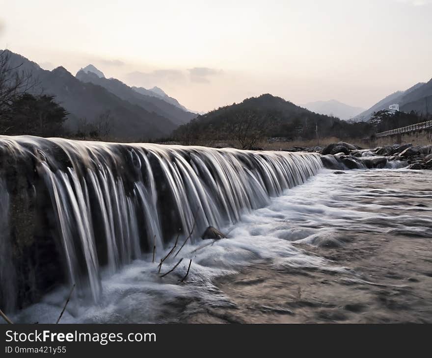 Mountain river. Water on river rapids. Photo on exposure