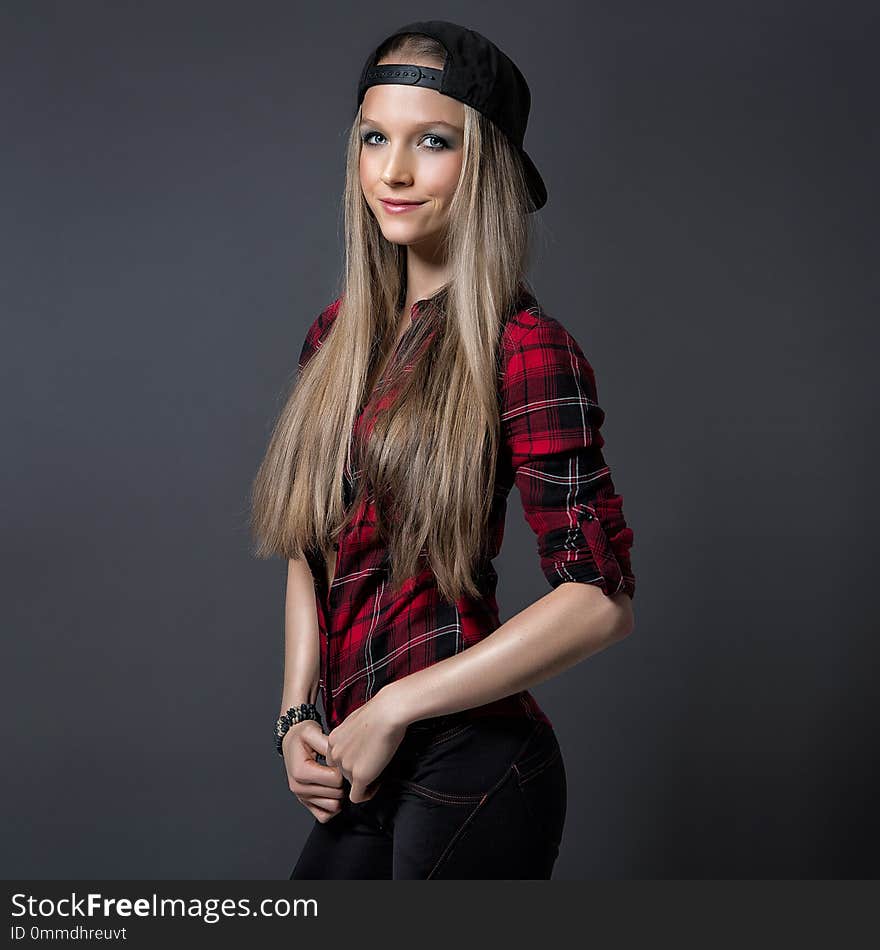 Potrait slim blonde young girl in red shirt and cap