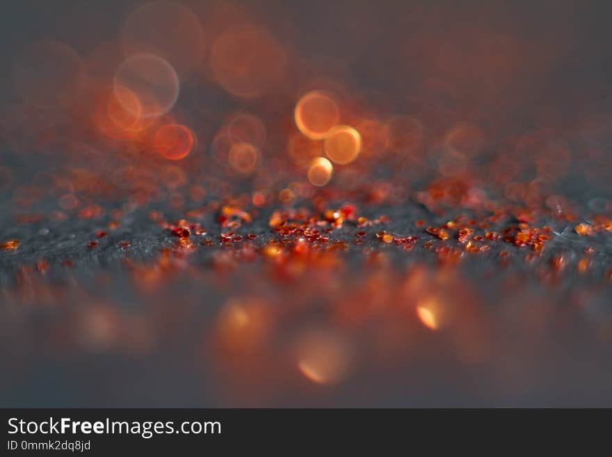 Abstract red bokeh on a black background. Defocused. Free space for text.