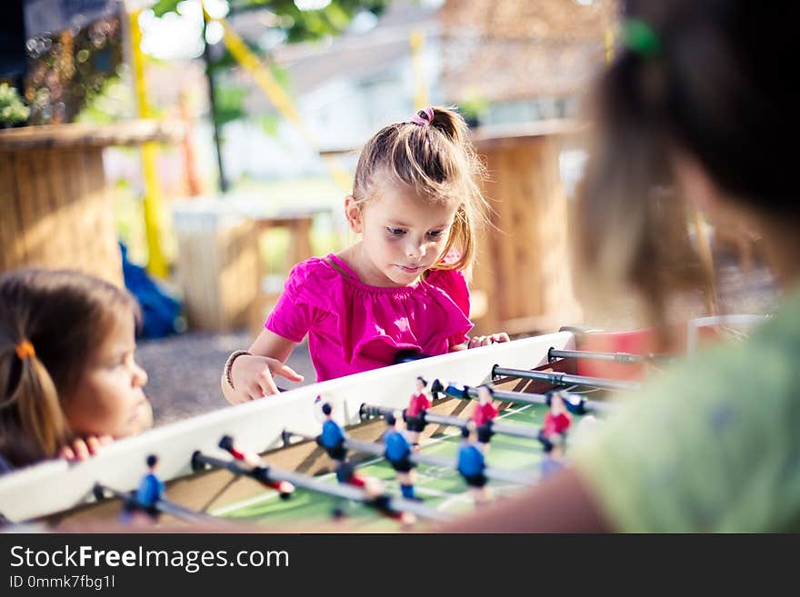 Competition. Three little girls playing together. Focus on background. Close up.