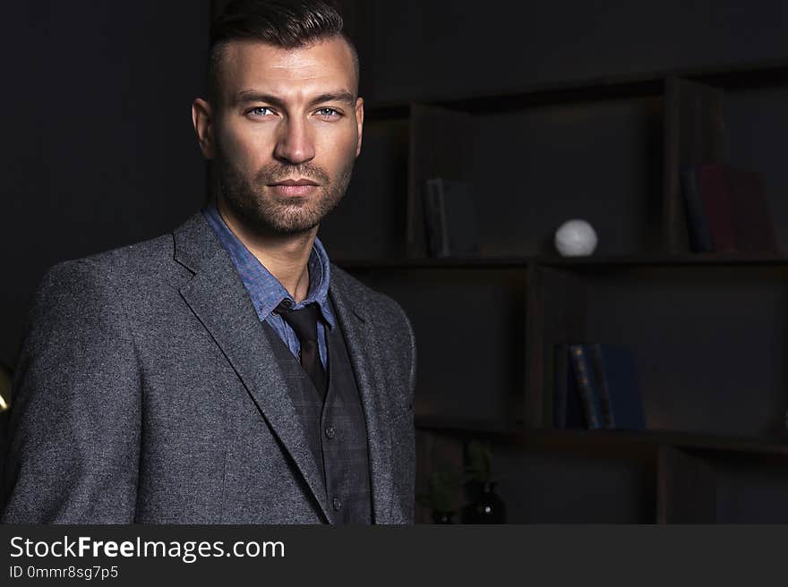 Portrait of a handsome stylish man in a suit. Business man with a confident look