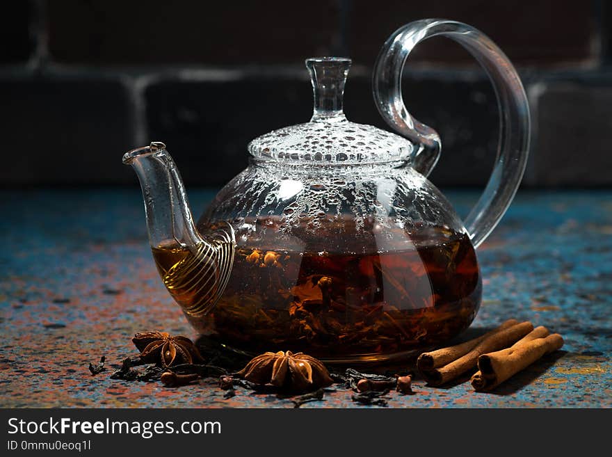 Tea masala in a glass teapot on dark background