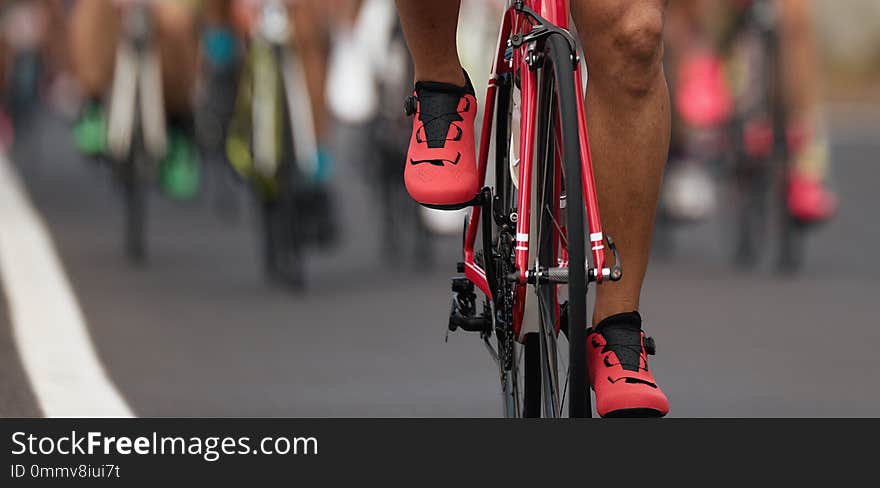 Cycling competition cyclist athletes riding a race at high speed, detail of cycling shoes