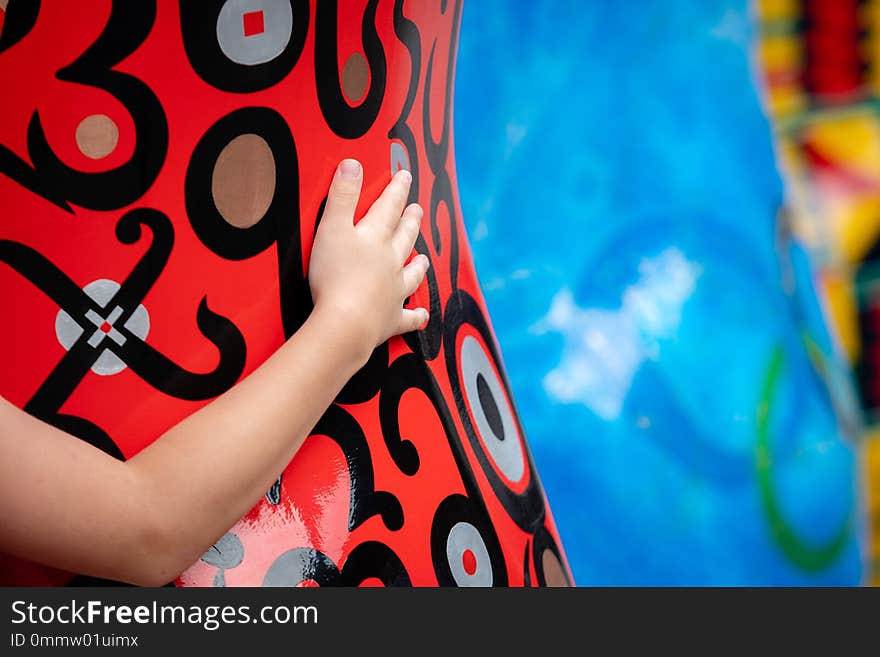 Childrens hand on a large bearded figure.