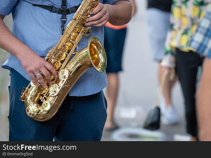 The street musician playing saxophone.